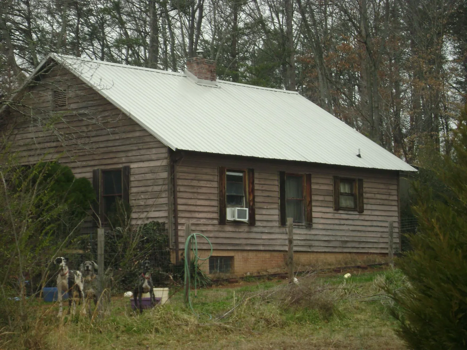 White metal roof on an old wood sided farmhouse, from a Metal Roof Installation job in Kirklin